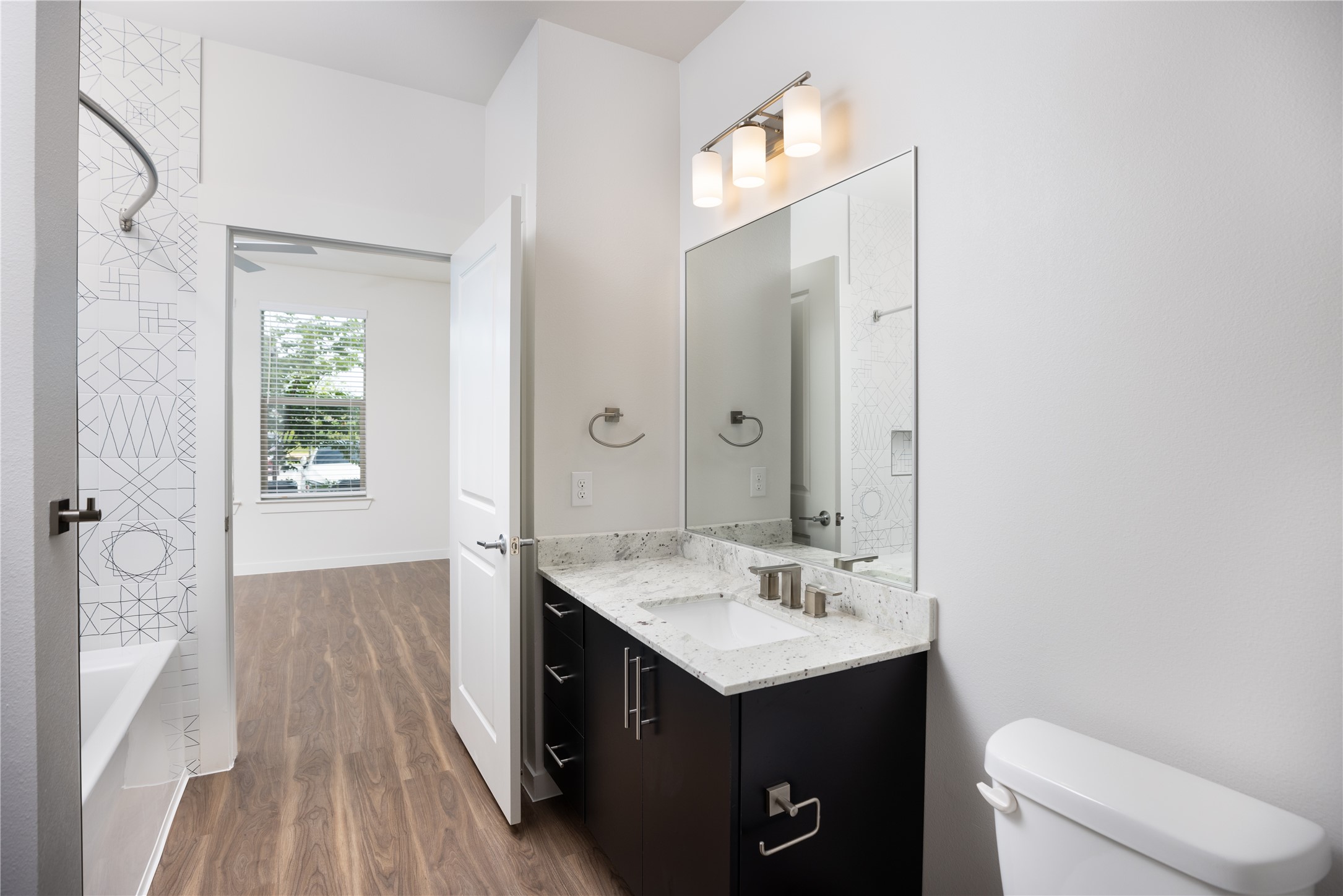 9302 Fry Road, Unit B11034 Cypress, TX 77433 - Photo 10 of 12 a bathroom with a sink vanity granite and toilet