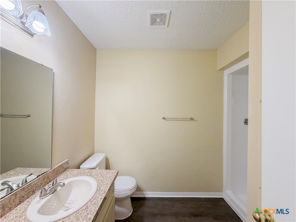3806 Shallow Ford Road Temple, TX 76502 - Photo 14 of 20 a bathroom with a granite countertop sink toilet and a mirror