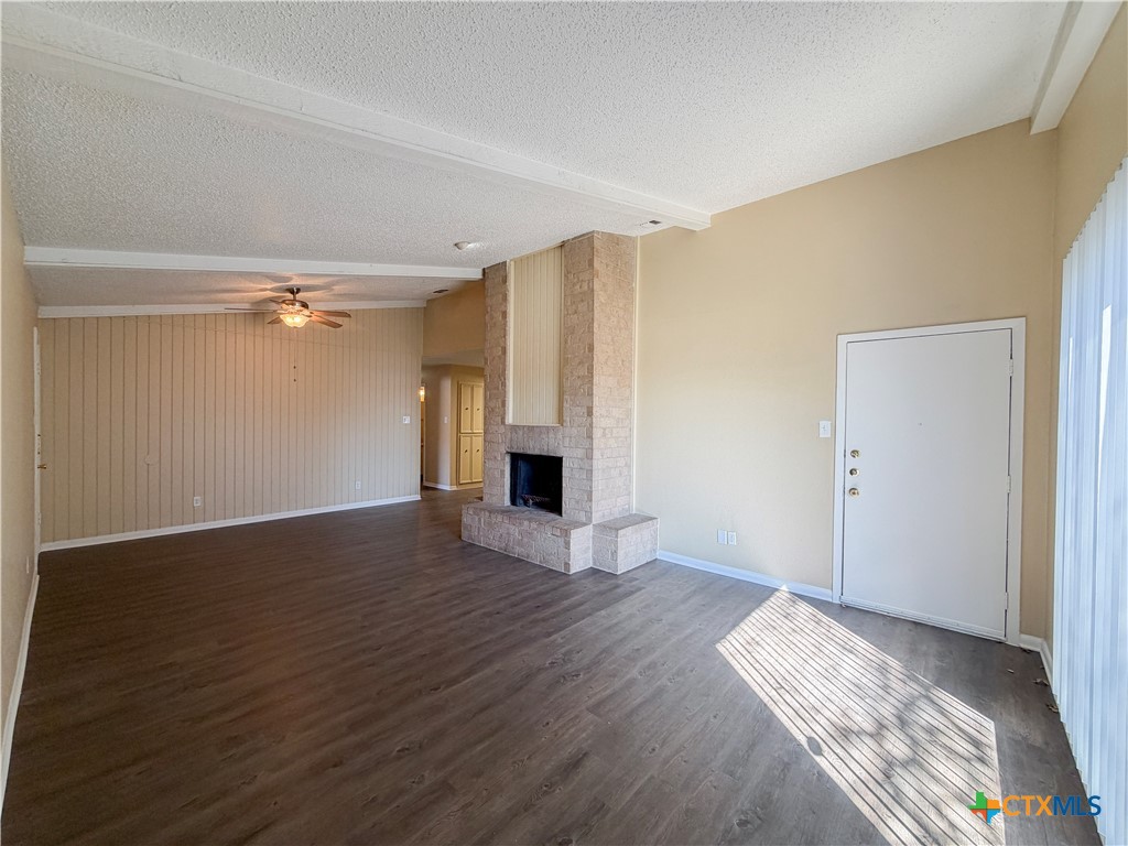 3806 Shallow Ford Road Temple, TX 76502 - Photo 2 of 20 a view of empty room with wooden floor and fireplace