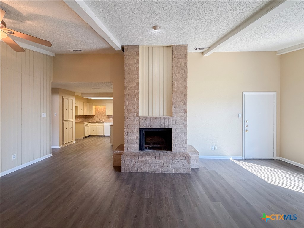 3806 Shallow Ford Road Temple, TX 76502 - Photo 3 of 20 an empty room with wooden floor fireplace and windows