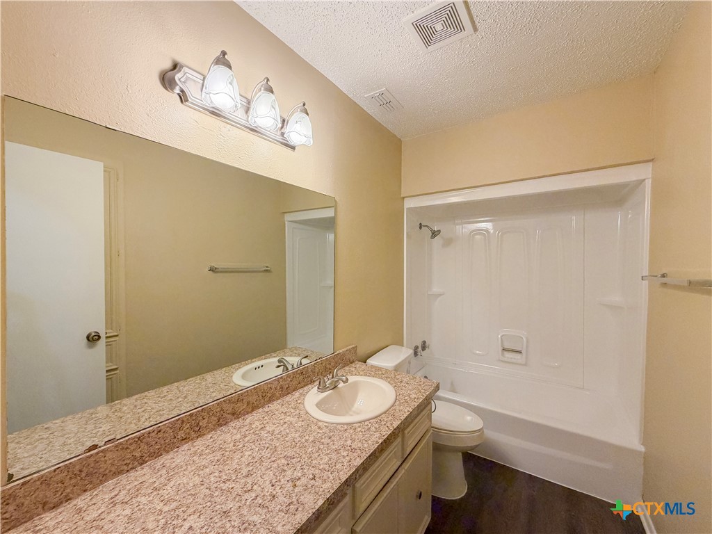 3806 Shallow Ford Road Temple, TX 76502 - Photo 9 of 20 a bathroom with a granite countertop sink a toilet and shower