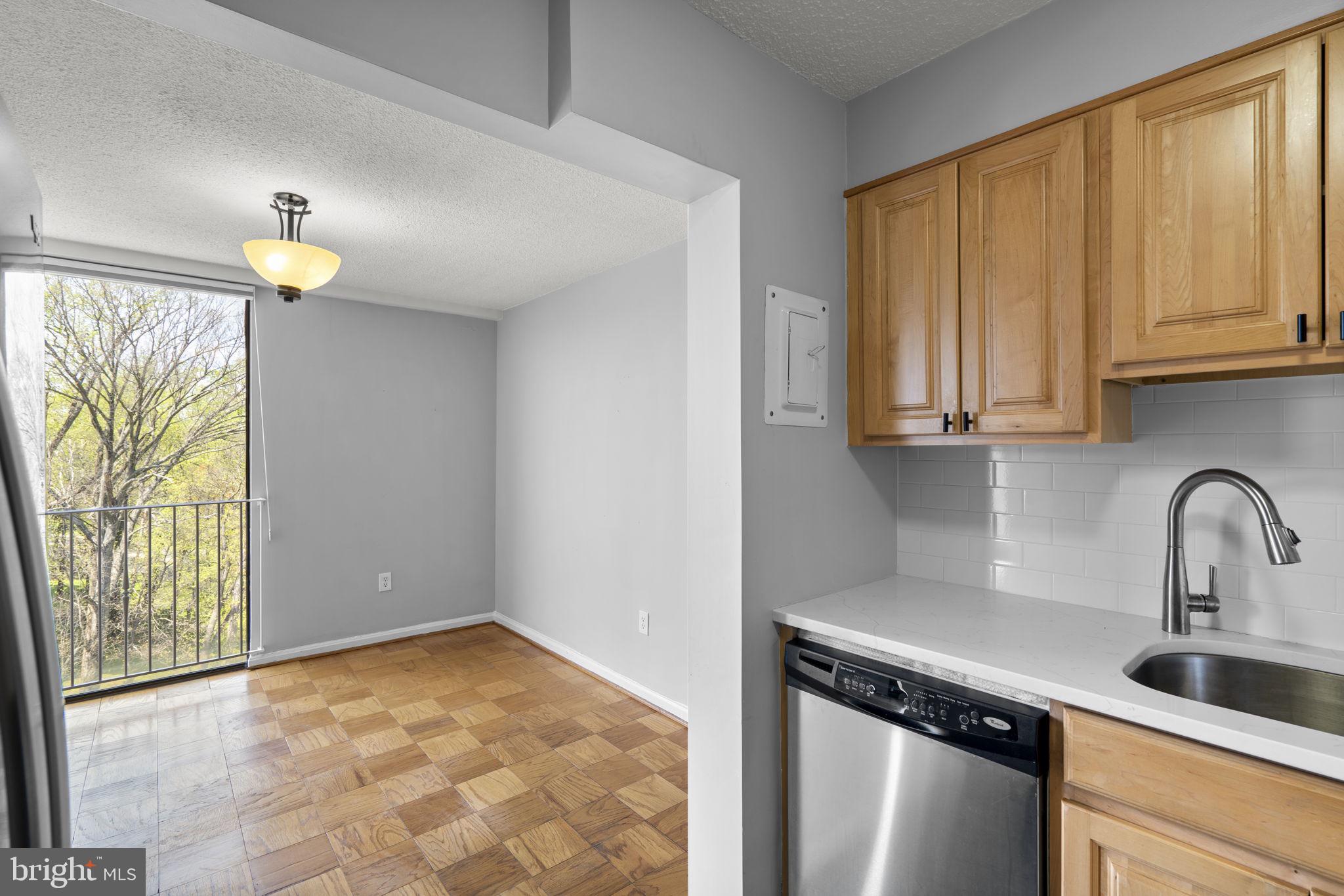 2100 Washington Avenue, Unit 9D Silver Spring, MD 20910 - Photo 17 of 29 a kitchen with stainless steel appliances granite countertop a sink a stove and a window