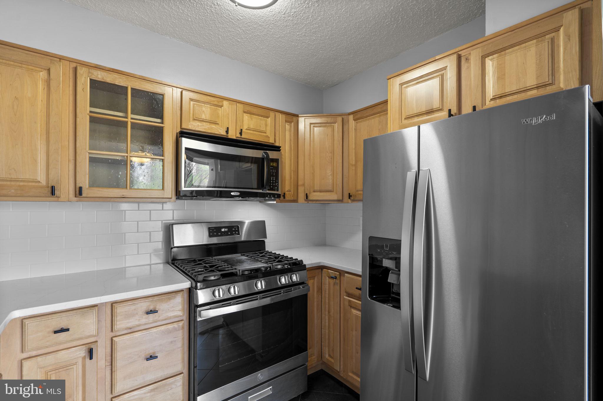 2100 Washington Avenue, Unit 9D Silver Spring, MD 20910 - Photo 20 of 29 a kitchen with stainless steel appliances granite countertop a refrigerator stove and microwave
