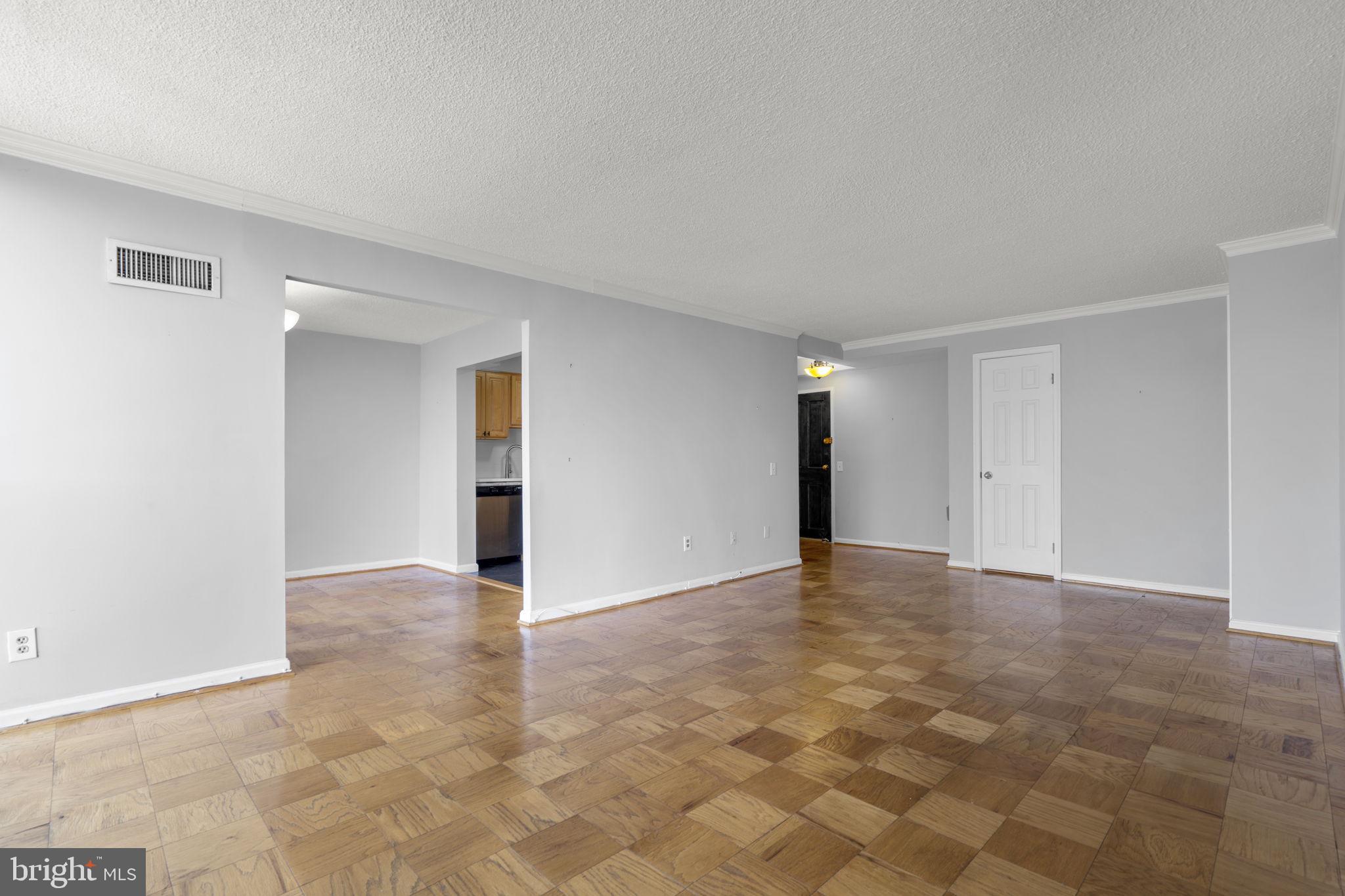 2100 Washington Avenue, Unit 9D Silver Spring, MD 20910 - Photo 25 of 29 a view of an empty room with wooden floor
