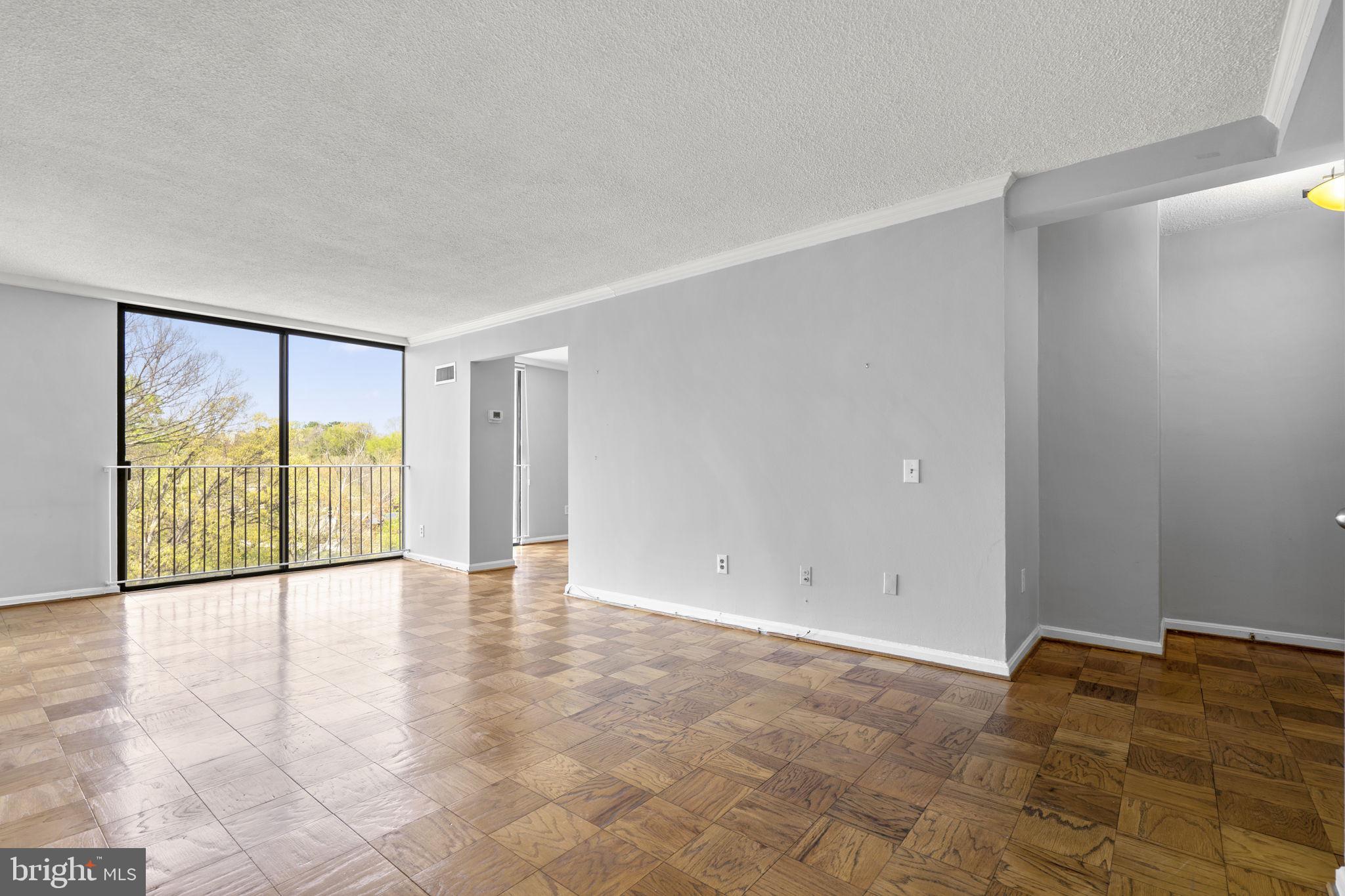 2100 Washington Avenue, Unit 9D Silver Spring, MD 20910 - Photo 26 of 29 a view of an empty room with wooden floor and a window