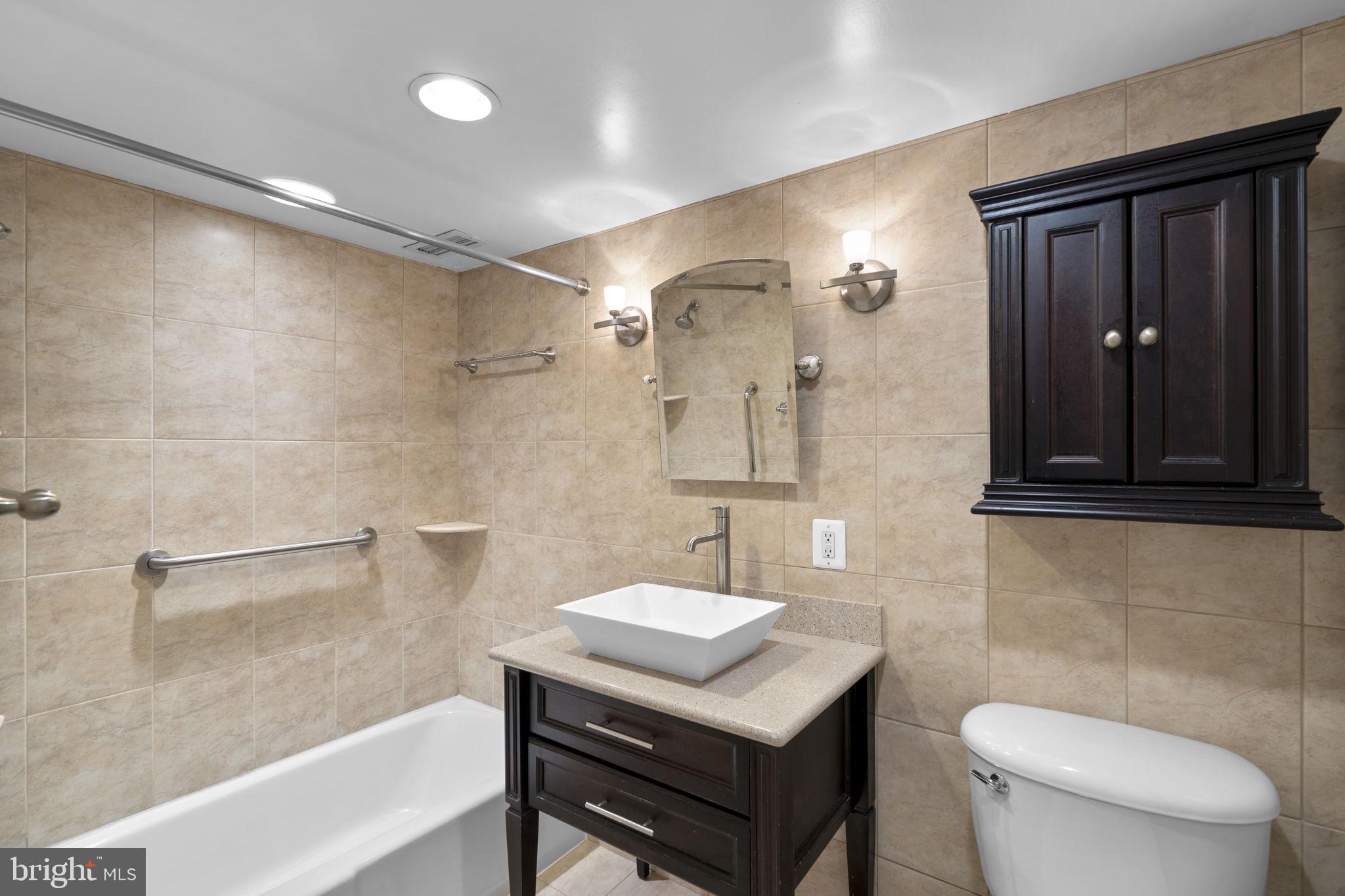 2100 Washington Avenue, Unit 9D Silver Spring, MD 20910 - Photo 10 of 29 a bathroom with a sink a toilet and shower