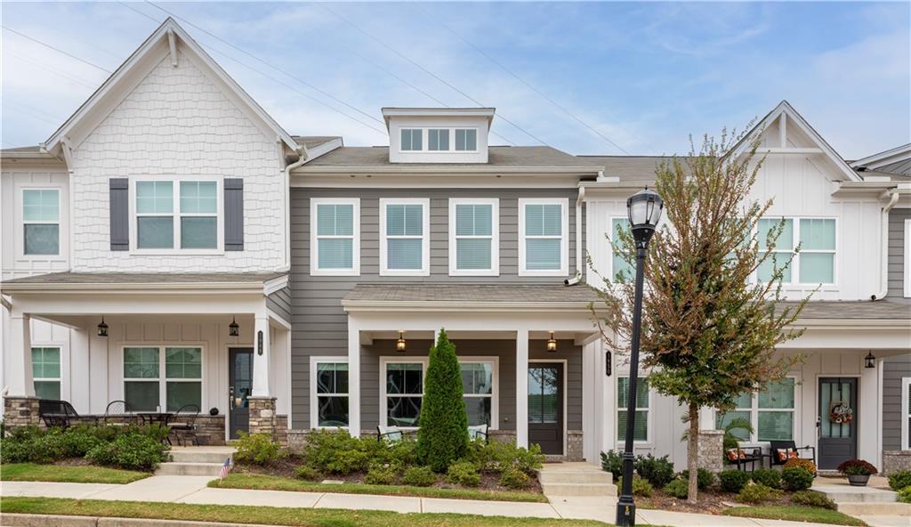 front view of a brick house with a yard