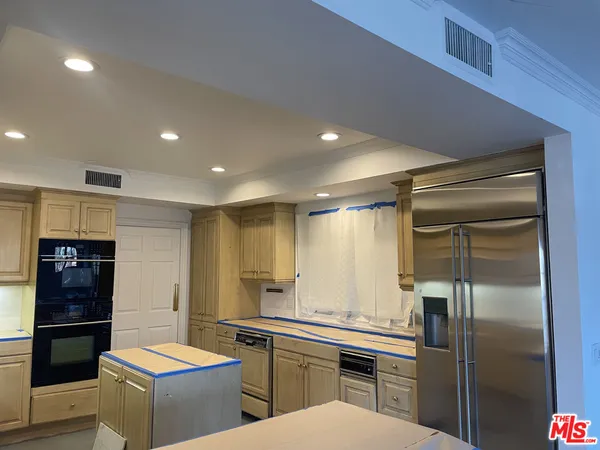 a kitchen that has a sink and a microwave