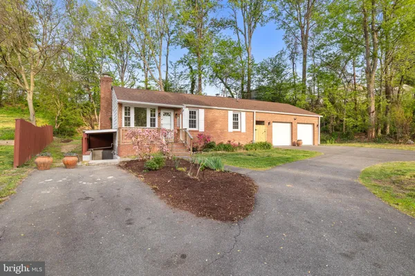 a living room with a baby crib furniture a fireplace and a wooden floor