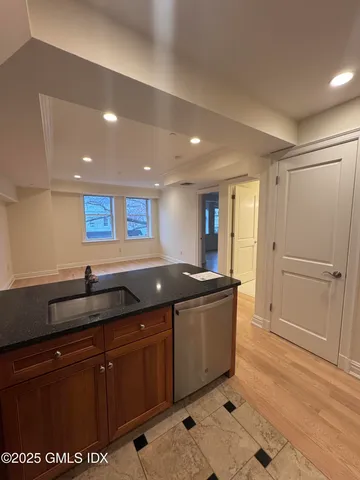a kitchen with granite countertop a sink and cabinets
