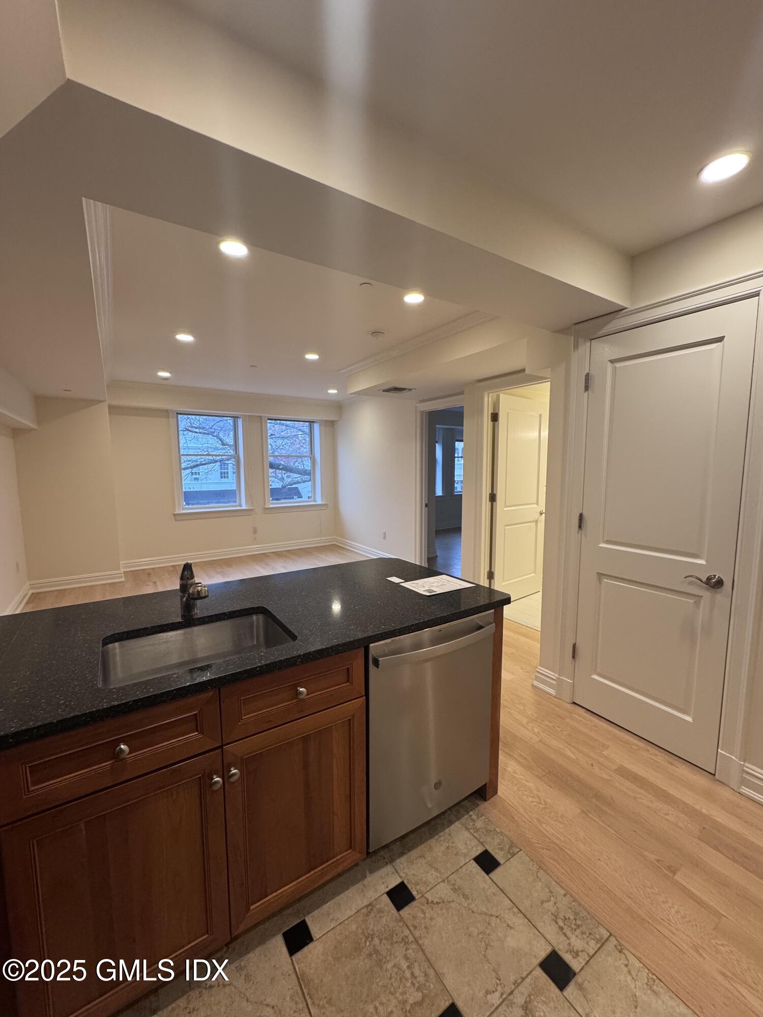 275 Greenwich Avenue, Unit 2B Greenwich, CT 06830 - Photo 4 of 8 a kitchen with granite countertop a sink and cabinets