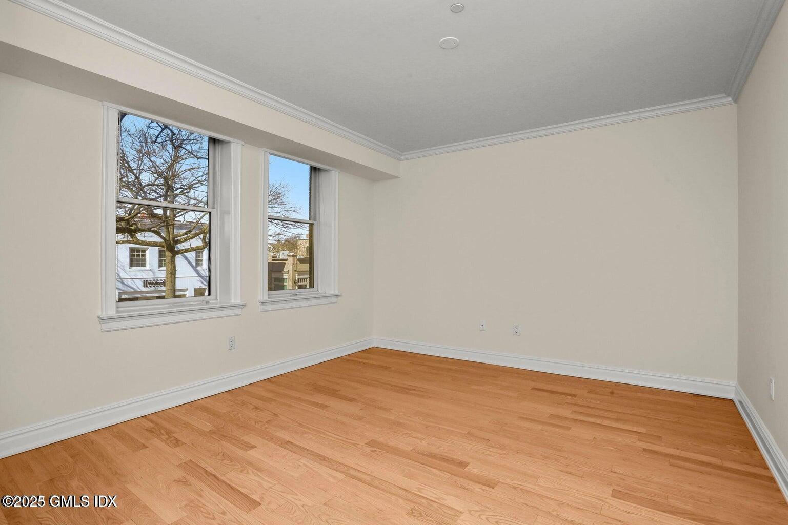275 Greenwich Avenue, Unit 2B Greenwich, CT 06830 - Photo 6 of 8 a view of empty room with wooden floor and fan
