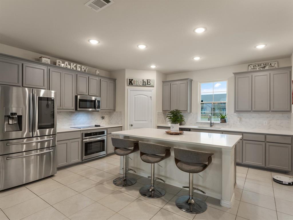 a kitchen with appliances cabinets and furniture