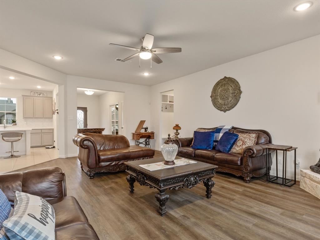 1009 Northern Oaks Court Springtown, TX 76082 - Photo 13 of 28 a living room with furniture a clock on wall and a table