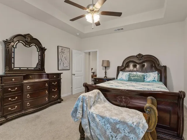 a bedroom with a bed and a dresser