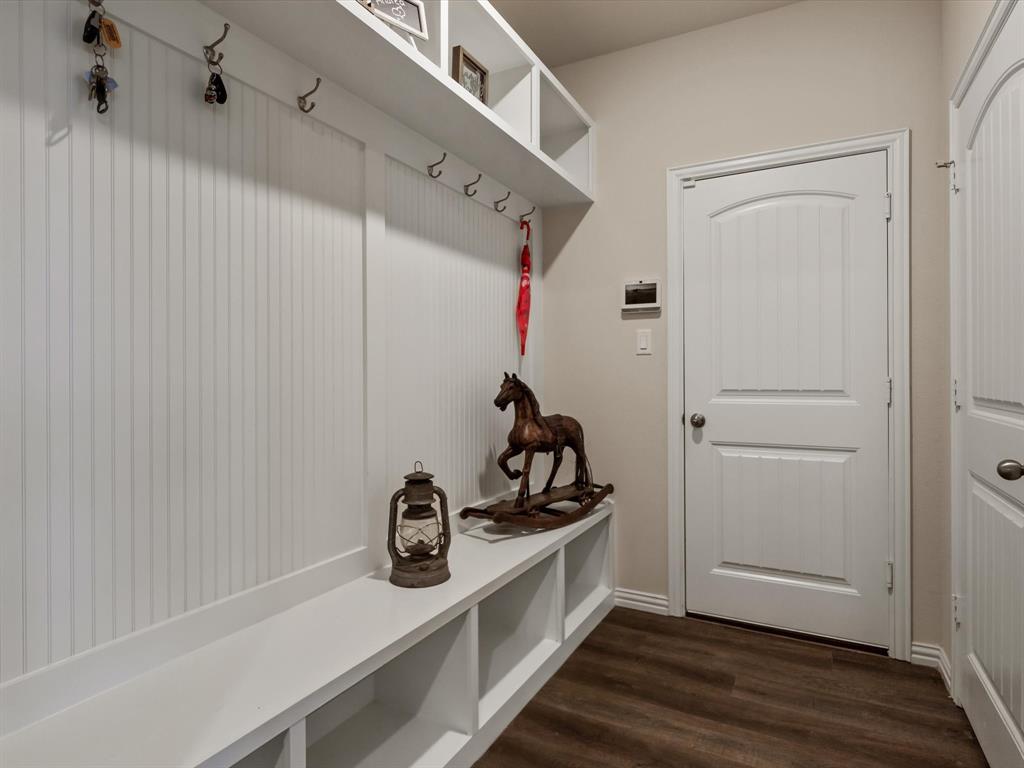 1009 Northern Oaks Court Springtown, TX 76082 - Photo 26 of 28 a view of a storage & utility room with wooden floor