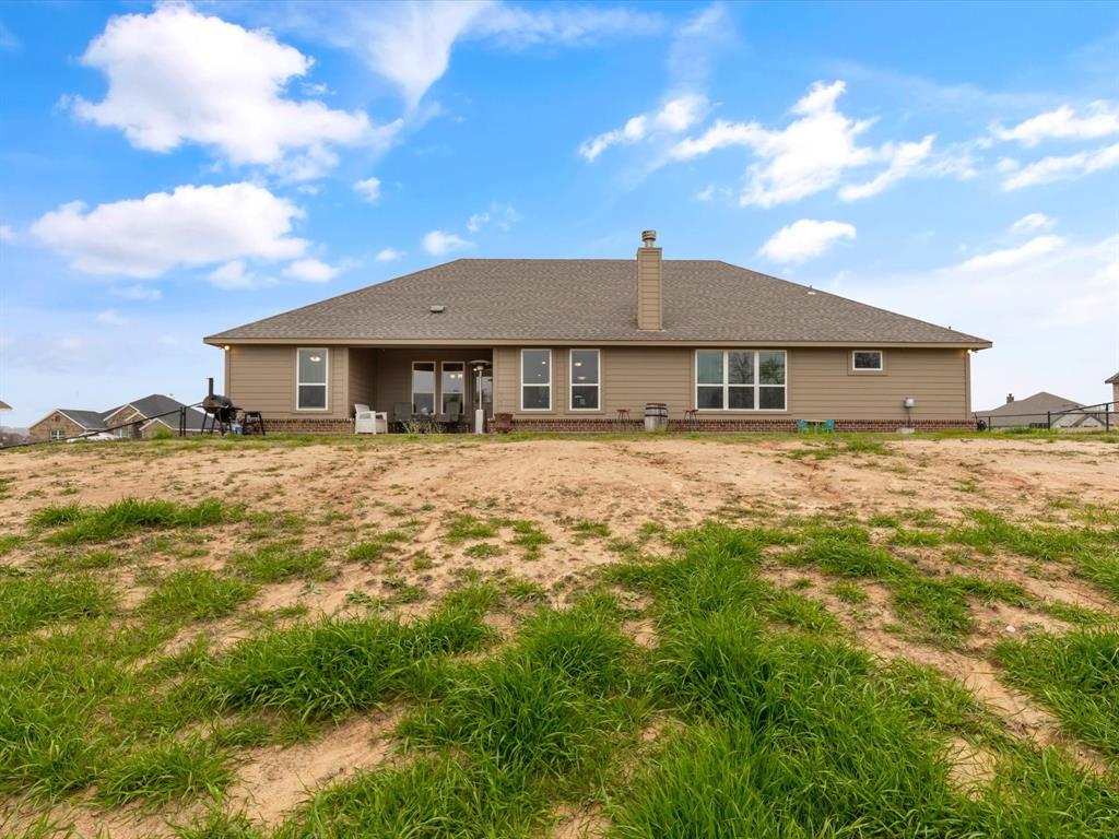 1009 Northern Oaks Court Springtown, TX 76082 - Photo 27 of 28 a front view of a house with a yard