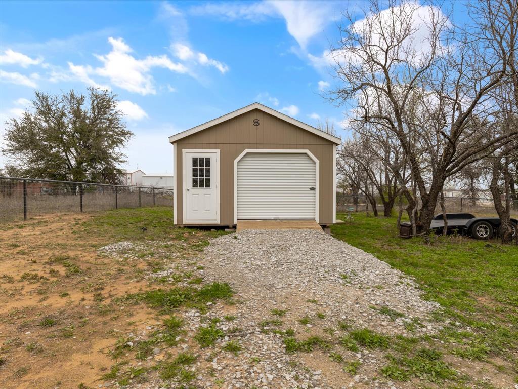 1009 Northern Oaks Court Springtown, TX 76082 - Photo 28 of 28 a view of a house with a yard