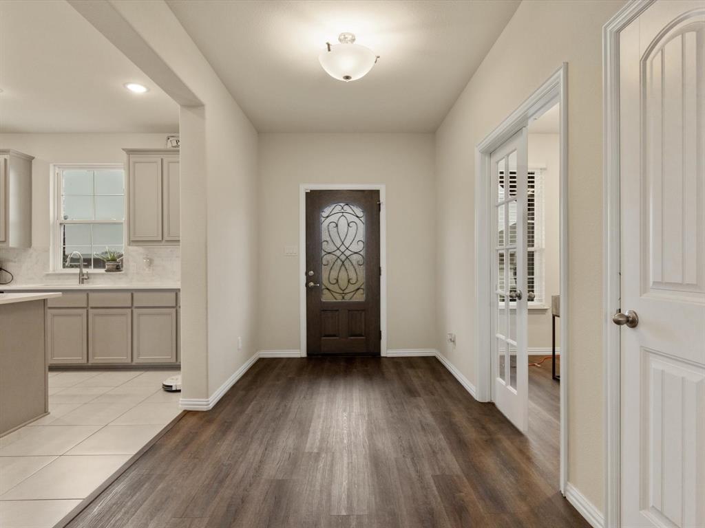 1009 Northern Oaks Court Springtown, TX 76082 - Photo 4 of 28 a view of a hallway to a bedroom with wooden floor and closet