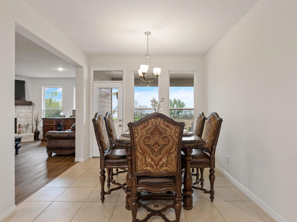 1009 Northern Oaks Court Springtown, TX 76082 - Photo 5 of 28 a view of a dining room with furniture and chandelier