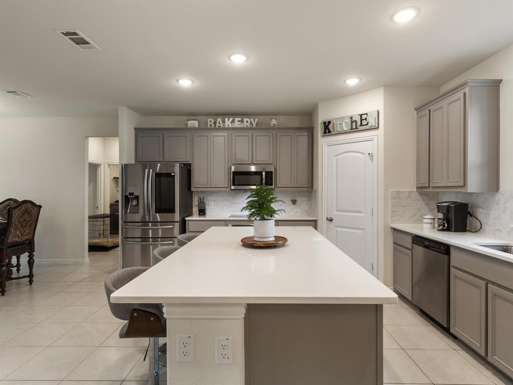 1009 Northern Oaks Court Springtown, TX 76082 - Photo 7 of 28 a kitchen with refrigerator and chairs