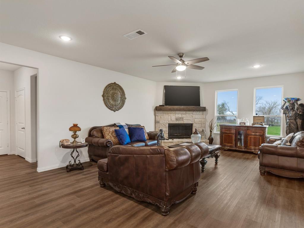 1009 Northern Oaks Court Springtown, TX 76082 - Photo 9 of 28 a living room with furniture a fireplace and wooden floor