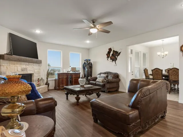 a living room with furniture fireplace and a flat screen tv