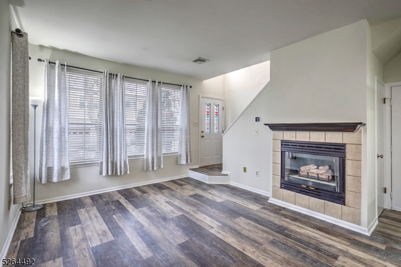 70 High Pond Lane Bedminster, NJ 07921 - Photo 5 of 23 a view of an empty room with wooden floor fireplace and a window