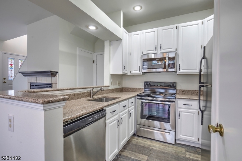 70 High Pond Lane Bedminster, NJ 07921 - Photo 7 of 23 a kitchen with stainless steel appliances granite countertop a sink stove and refrigerator