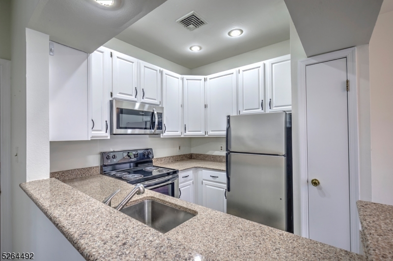70 High Pond Lane Bedminster, NJ 07921 - Photo 8 of 23 a kitchen with kitchen island a counter top space a sink stainless steel appliances and cabinets