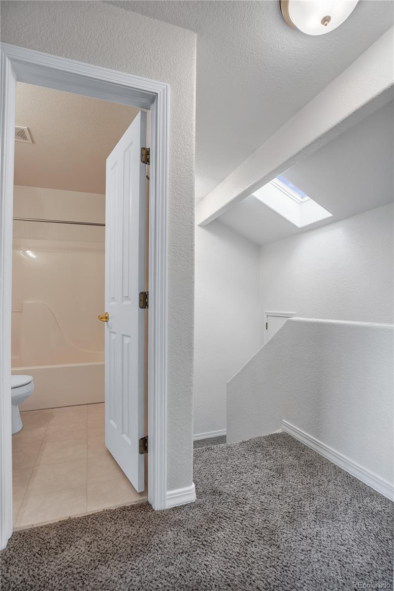 11690 West 46th Avenue Wheat Ridge, CO 80033 - Photo 19 of 33 a view of a bathroom with a glass door shower