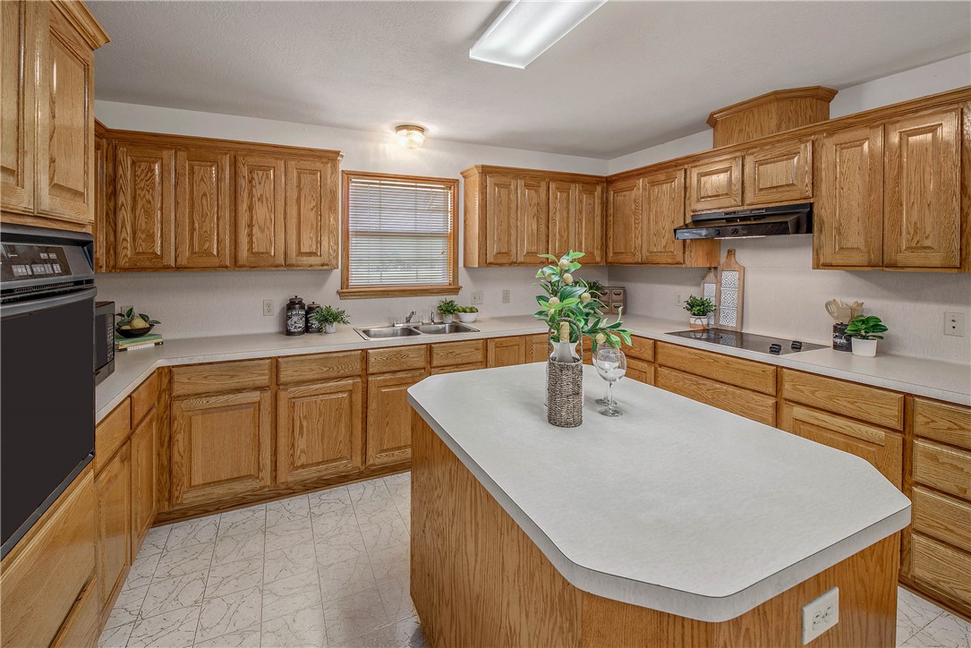 1110 County Road 439 Dime Box, TX 77853 - Photo 20 of 50 a kitchen with stainless steel appliances granite countertop a sink a stove and a refrigerator