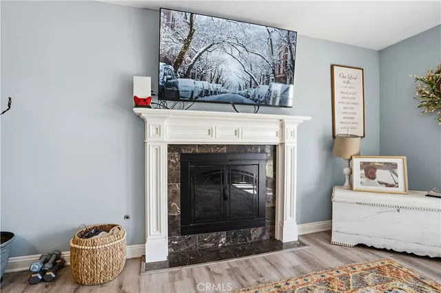 a living room with a fireplace and a wooden floor