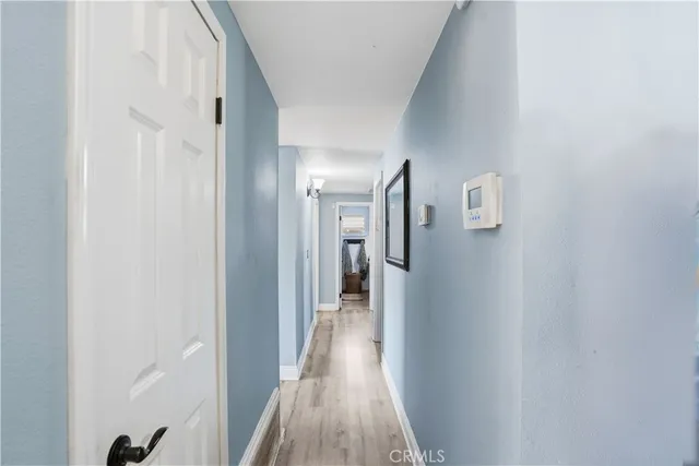 a view of a hallway with wooden floor