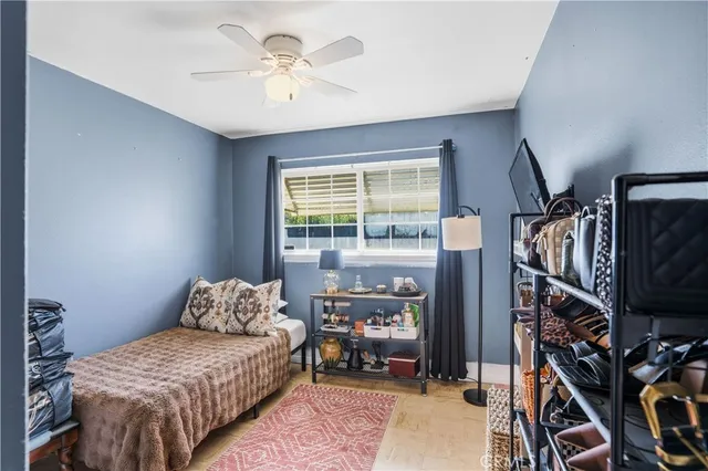 a bedroom with furniture and a flat screen tv