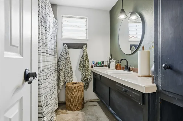 a bathroom with a sink mirror and vanity