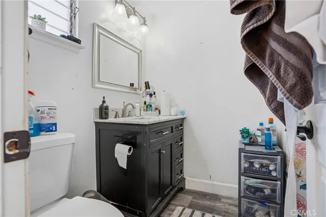 a bathroom with a sink a toilet and a mirror