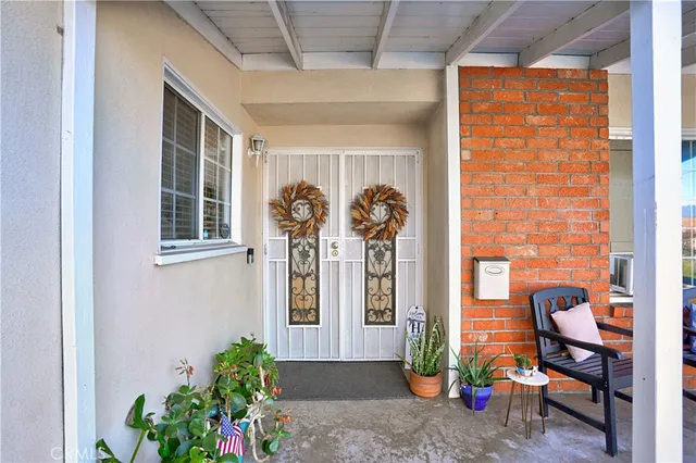 a front view of a house with outdoor seating