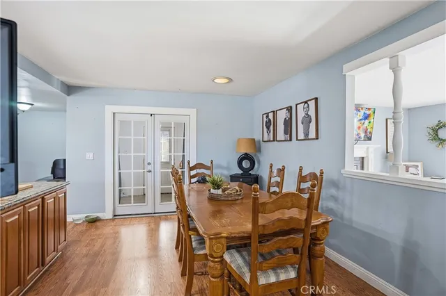 a dining room with furniture and wooden floor