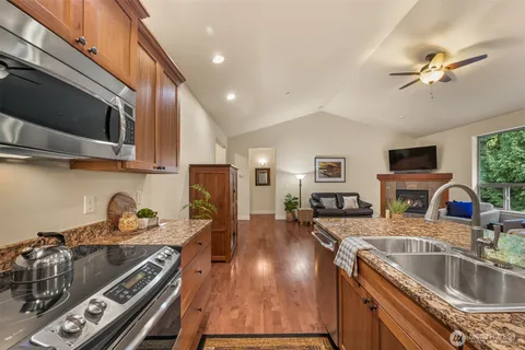 a kitchen with stainless steel appliances granite countertop a sink stove and refrigerator