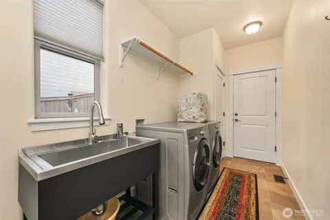 a utility room with cabinets washer and dryer