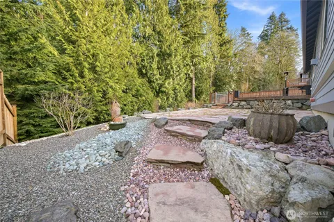 a view of a backyard with large trees