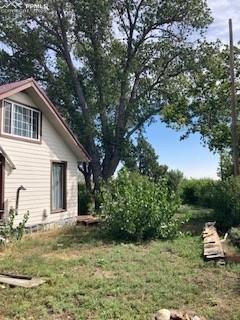 20490 Lemesany Road Calhan, CO 80808 - Photo 18 of 31 a backyard of a house with table and chairs