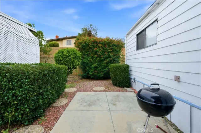 a backyard of a house with table and chairs