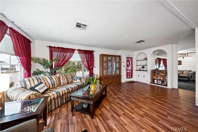 a living room with furniture and a book shelf