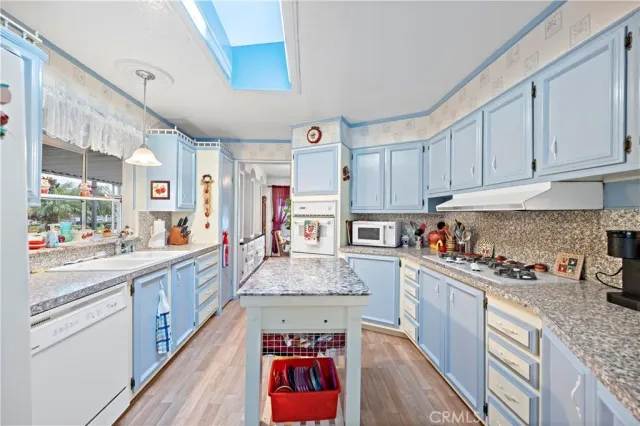 a kitchen with stainless steel appliances granite countertop a stove and a sink