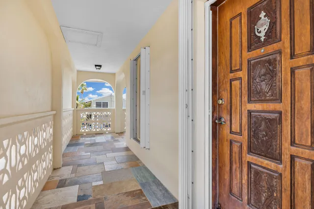 a view of an empty room with window and cabinet