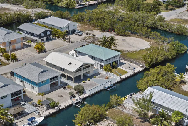 an aerial view of a house with a swimming pool