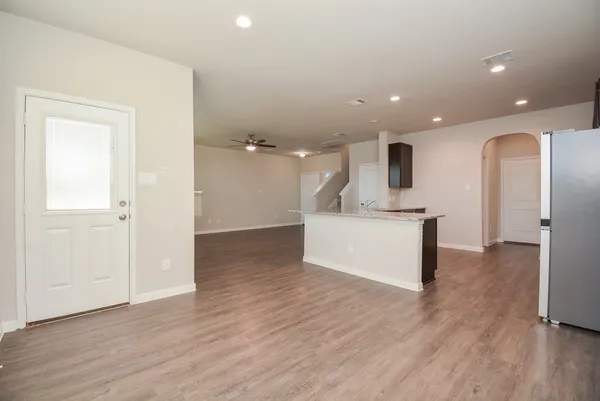 a view of kitchen with a sink wooden floor and a living room