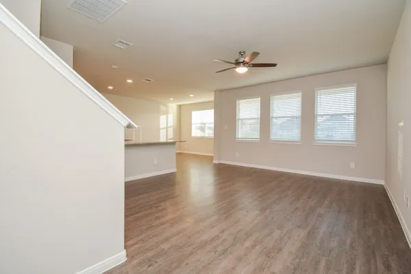 a kitchen with stainless steel appliances granite countertop wooden cabinets and wooden floor